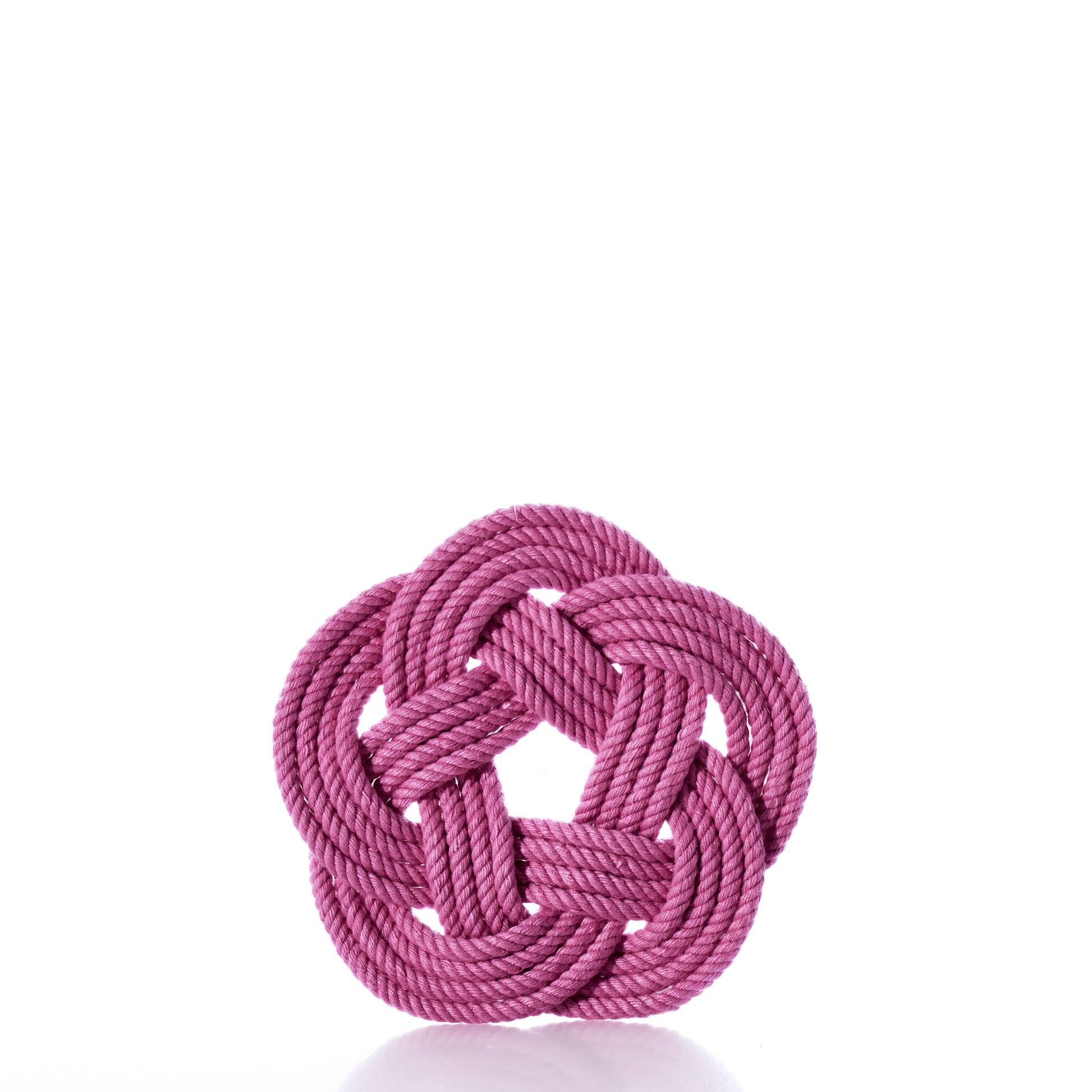 A Nautical Sailor Knot Coaster Set of 4 - Pink by true is arranged in a decorative, symmetrical knot with a circular pattern and displayed against a white background. by Sea Bags