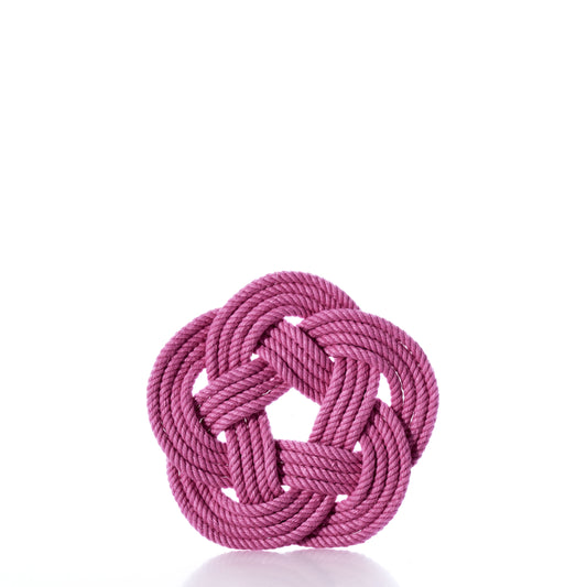 A Nautical Sailor Knot Coaster Set of 4 - Pink by true is arranged in a decorative, symmetrical knot with a circular pattern and displayed against a white background. by Sea Bags