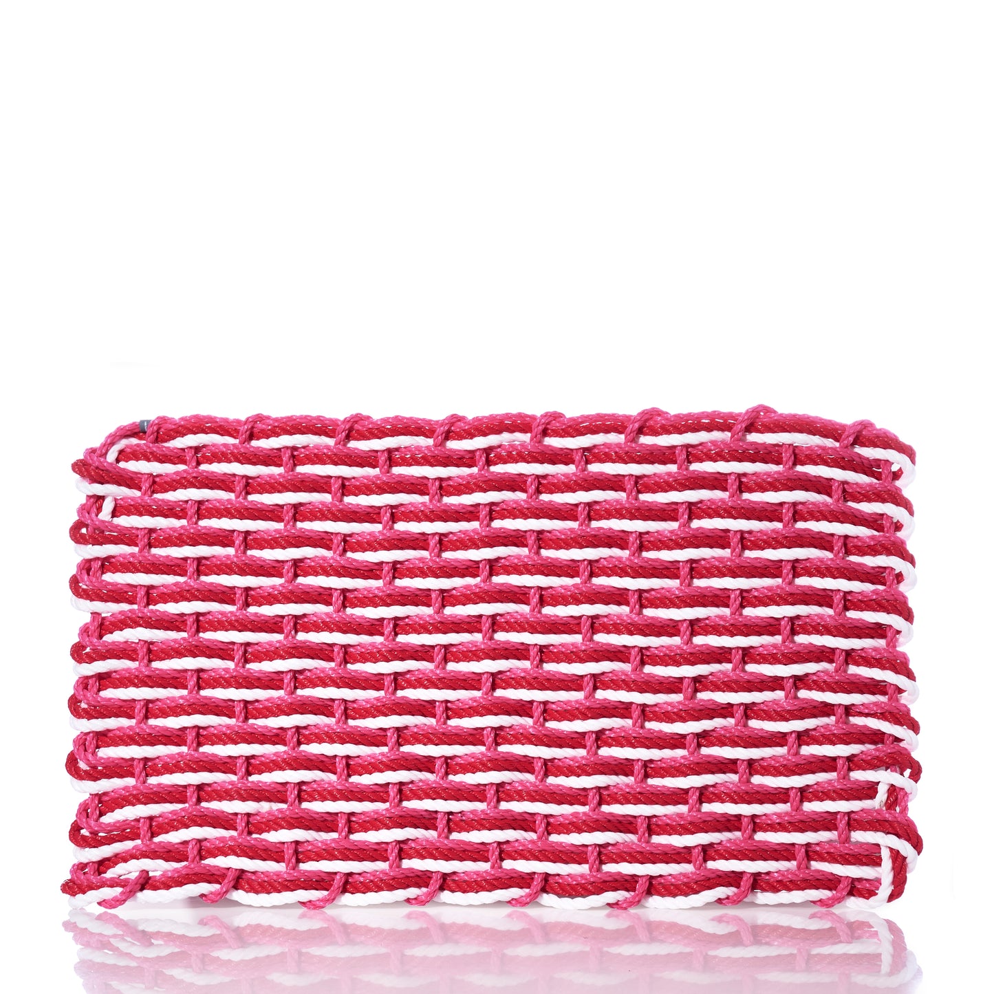 The Fisherman Rope Mat in Red, Pink,  White by Advanced Industrial Solutions Inc features a rectangular design with thick, interlaced strands in pink and white tones and a glossy finish—evoking the eco-friendly charm and cottage-core appeal of a woven clutch. by Sea Bags