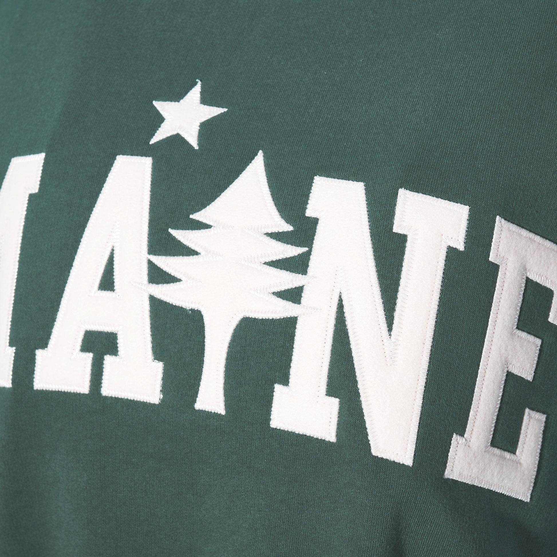 Showcase your love for the Pine Tree State with the Soft As A Grape Crewneck Pullover - Willow Maine Tree. This green crewneck features MAINE in white letters, with the I cleverly replaced by a pine tree topped with a star, giving this camp-style sweater a fresh outdoor vibe—perfect for anyone who appreciates Maine’s natural beauty. by Sea Bags