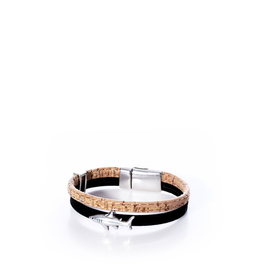 The Classic Cork Bracelet - Shark on Black by Elisabetta Studio showcases a black Portuguese cork band, accented with an antique silver shark charm and a modern magnetic clasp, beautifully presented against a white background. by Sea Bags