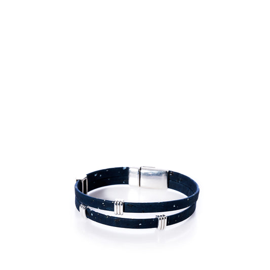 A Classic Cork Bracelet - Stripe Bands on Navy by Elisabetta Studio, featuring a double-wrap design in dark blue Portuguese cork with metallic accents and a rectangular magnetic clasp, is displayed on a white background. by Sea Bags