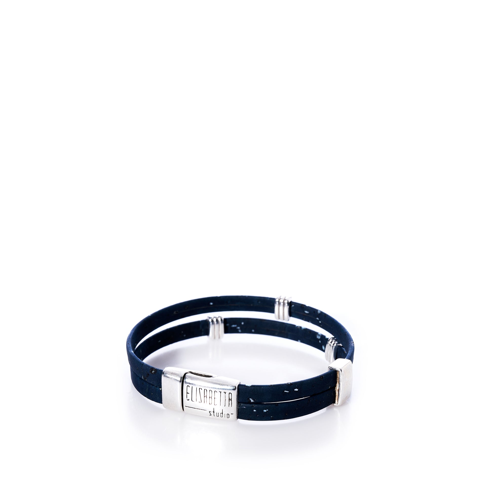 Classic Cork Bracelet - Stripe Bands on Navy by Elisabetta Studio features black double bands of Portuguese cork with silver accents and a rectangular magnetic clasp engraved with the Elisabetta Studio logo, displayed on a white background. by Sea Bags