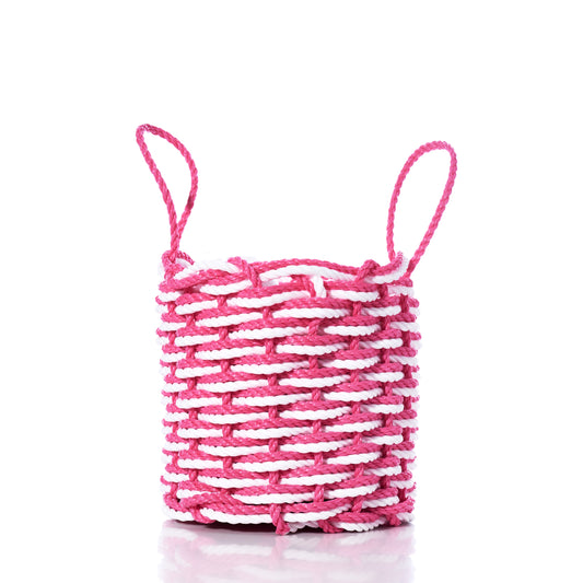 The Fisherman Rope Basket - Pink  White by Advanced Industrial Solutions Inc features two looped handles and is handwoven in Maine from eco-friendly materials, shown here on a white background. by Sea Bags