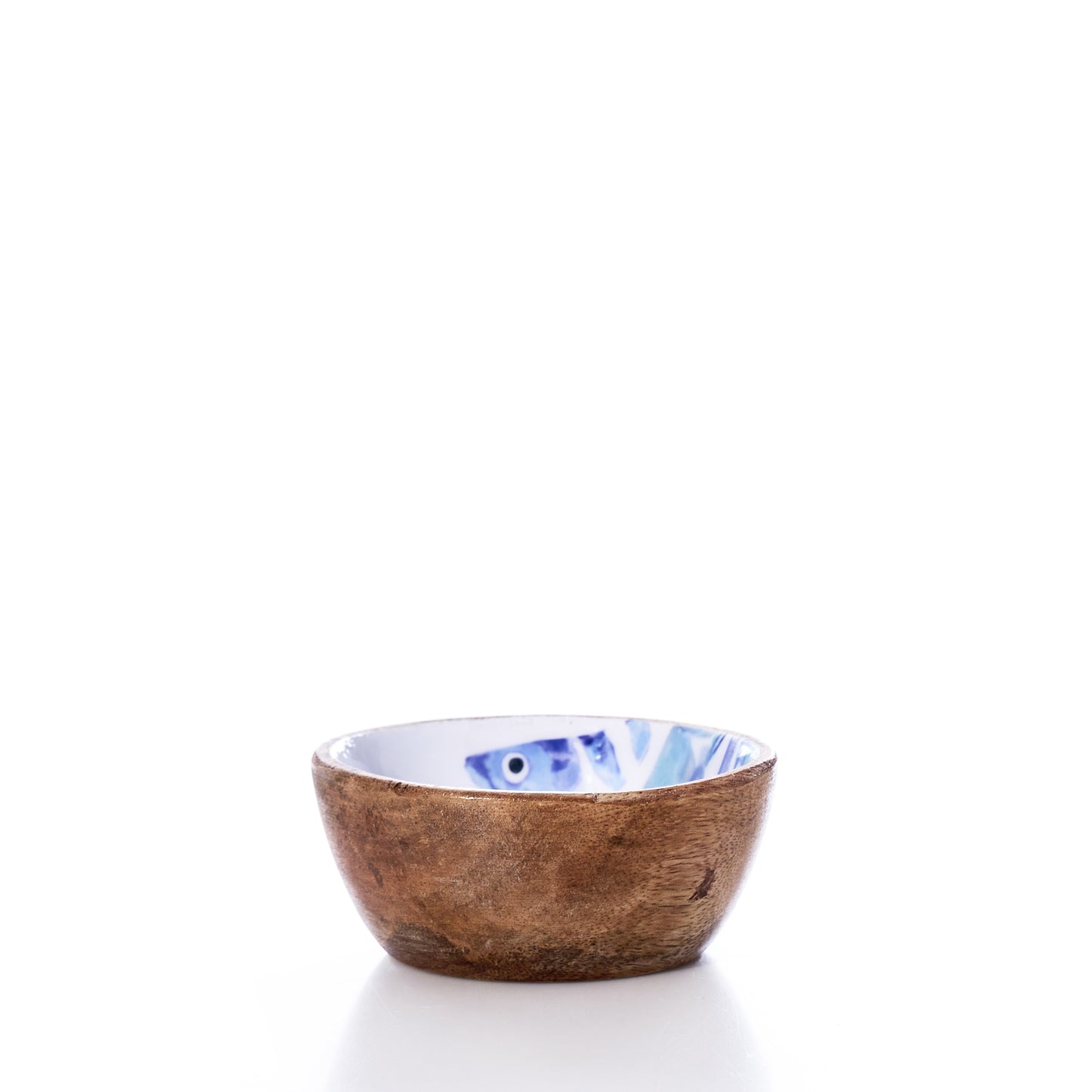 The Batela USA Inc Enameled Wood Bowl - Striped Fish is a small, round mango wood bowl featuring a brown textured exterior and a white enameled interior adorned with a blue striped fish design. Set against a white background, this charming bowl brings a subtle nautical touch to any table setting. by Sea Bags