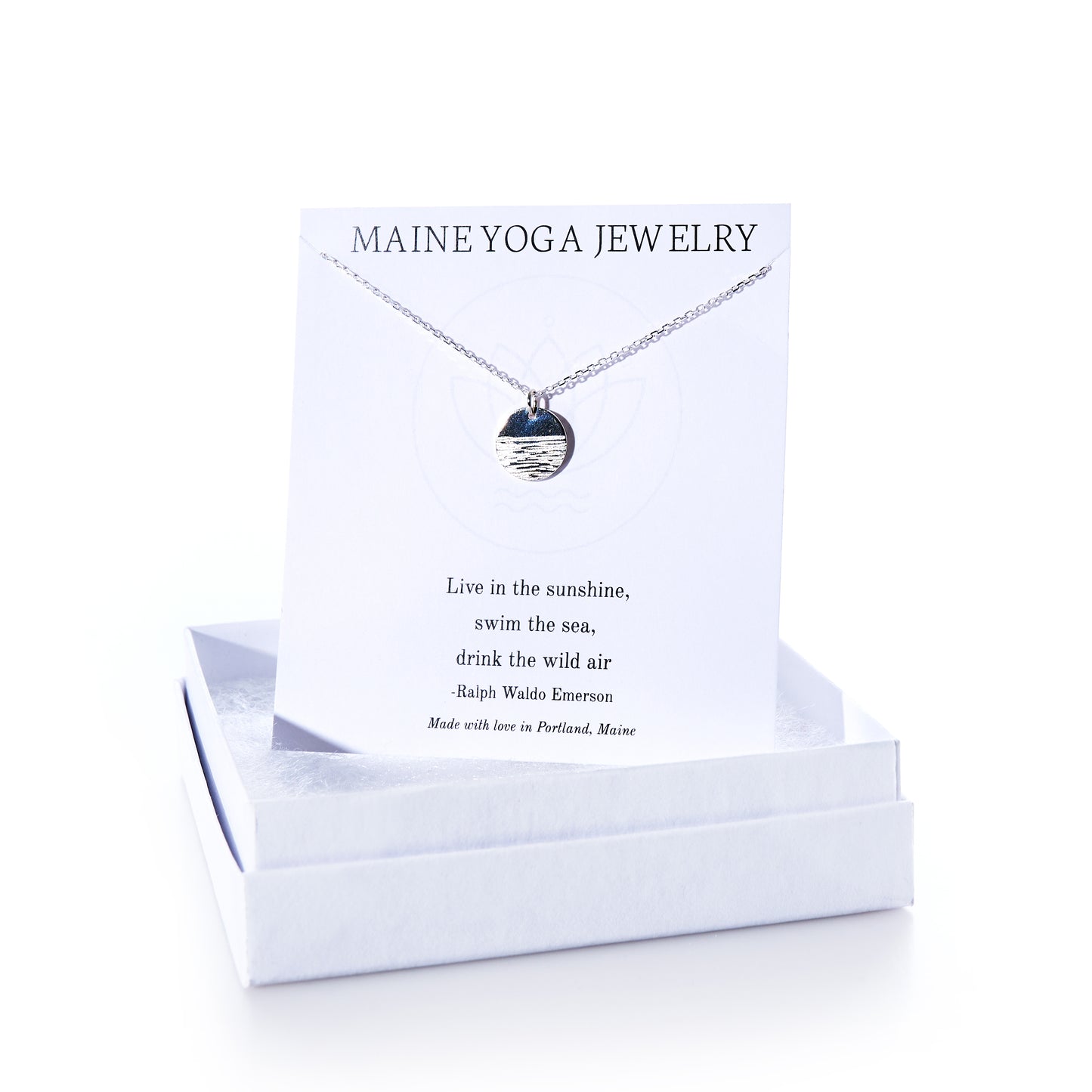 Horizon Silver pendant necklace by Maine Yoga Jewelry, featuring a round silver pendant displayed on a card with a Ralph Waldo Emerson quote, elegantly presented in a white jewelry box—an exquisite addition to any jewelry collection. by Sea Bags