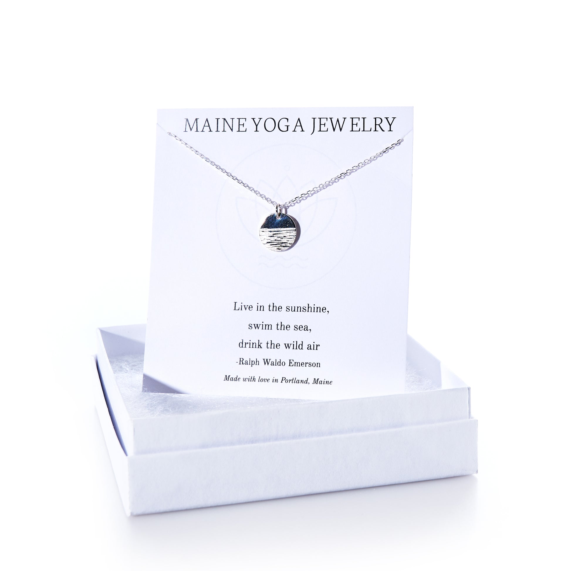 Horizon Silver pendant necklace by Maine Yoga Jewelry, featuring a round silver pendant displayed on a card with a Ralph Waldo Emerson quote, elegantly presented in a white jewelry box—an exquisite addition to any jewelry collection. by Sea Bags