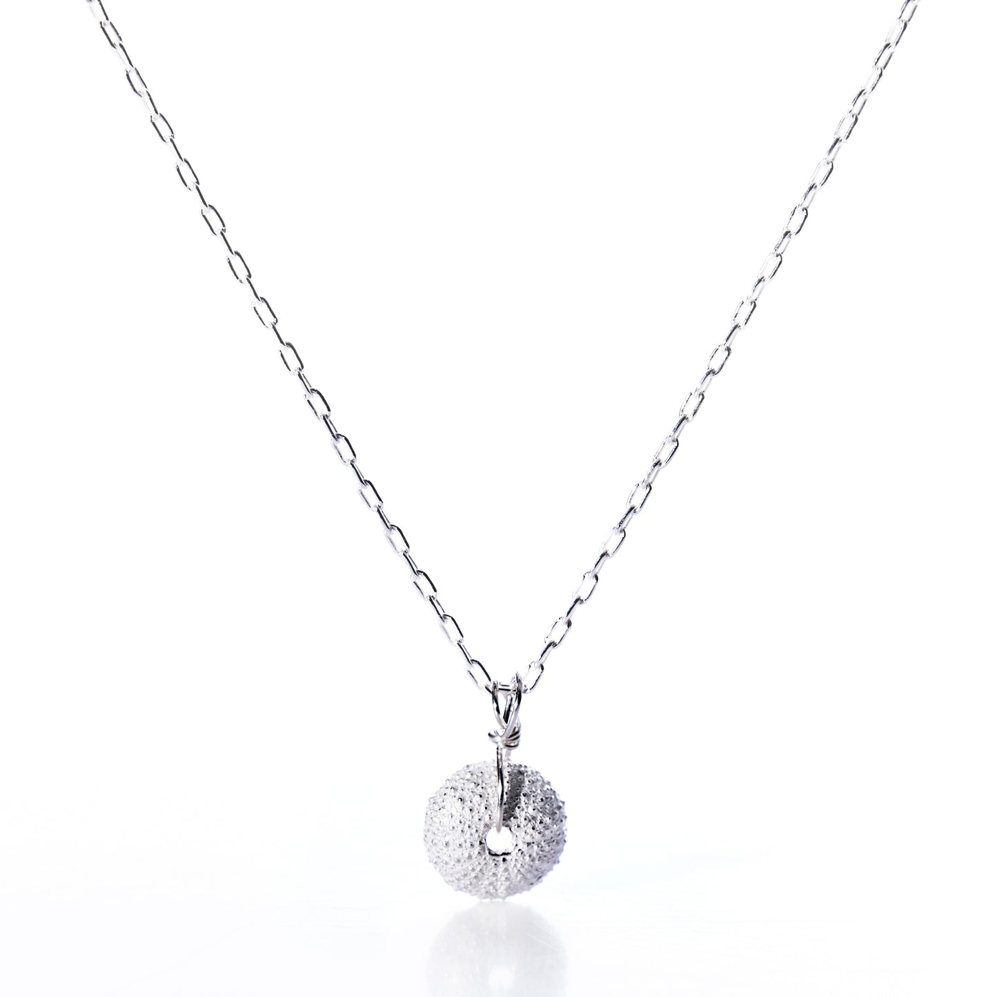Pendant Necklace - Tiny Sea Urchin Silver by Maine Yoga Jewelry, featuring a delicate silver chain and a handcrafted circular pendant inspired by a sea urchin, adorned with small white gemstones, shown on a white background. by Sea Bags