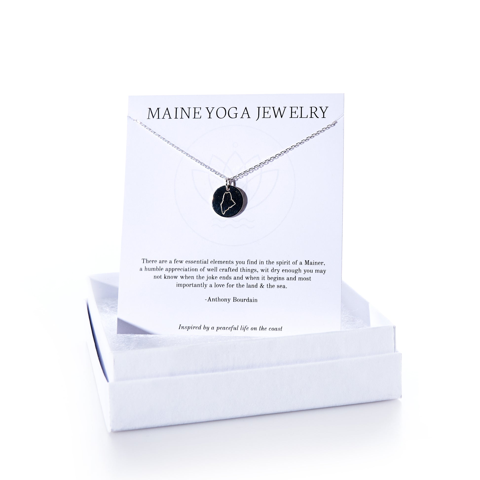 A Pendant Necklace - Silver Maine by Maine Yoga Jewelry is presented on a branded card inside an open white jewelry box, embodying the graceful style of coastal-inspired jewelry. by Sea Bags