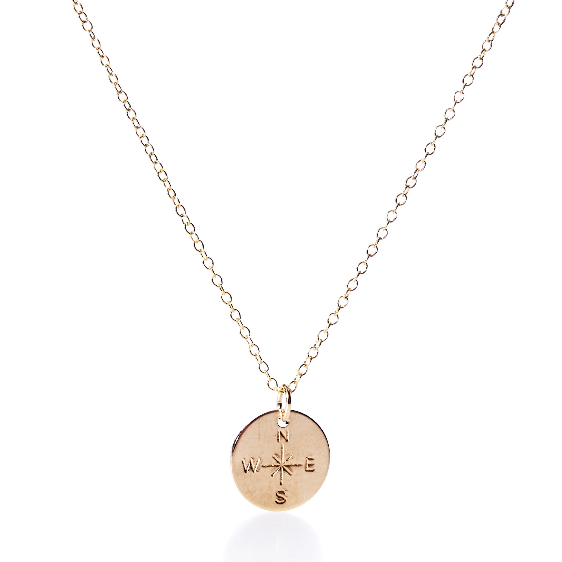 Discover the Pendant Necklace - Gold Compass Rose by Maine Yoga Jewelry, a gold chain necklace featuring a round pendant engraved with an intricate compass rose design and the letters N, E, S, and W. Thoughtfully made in Maine, this elegant nautical accessory is perfect for those drawn to adventure and timeless style. by Sea Bags