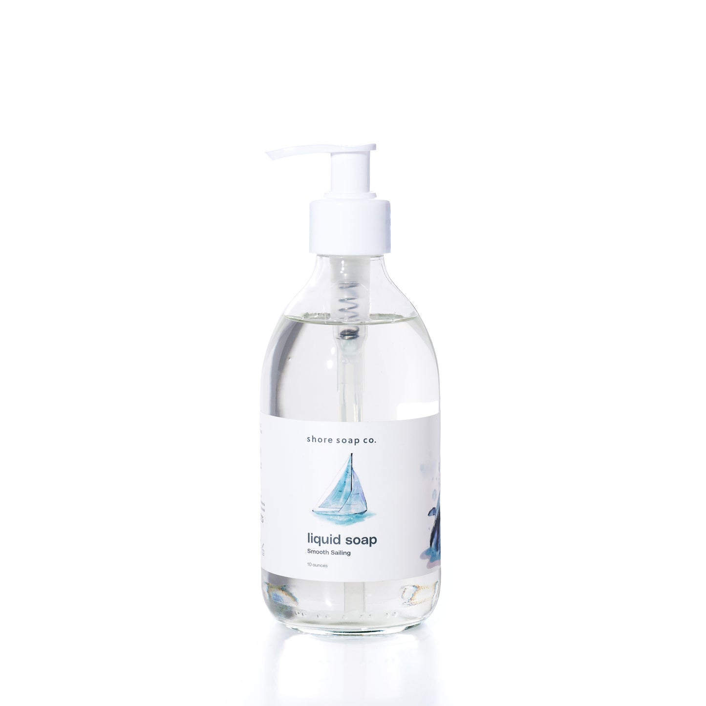 Smooth Sailing Eco-Friendly Liquid Soap by Shore Soap Co comes in a pump bottle featuring an illustration of a sailboat on the label. This gentle, pH-balanced formula is kind to skin, making it perfect for everyday use. by Sea Bags