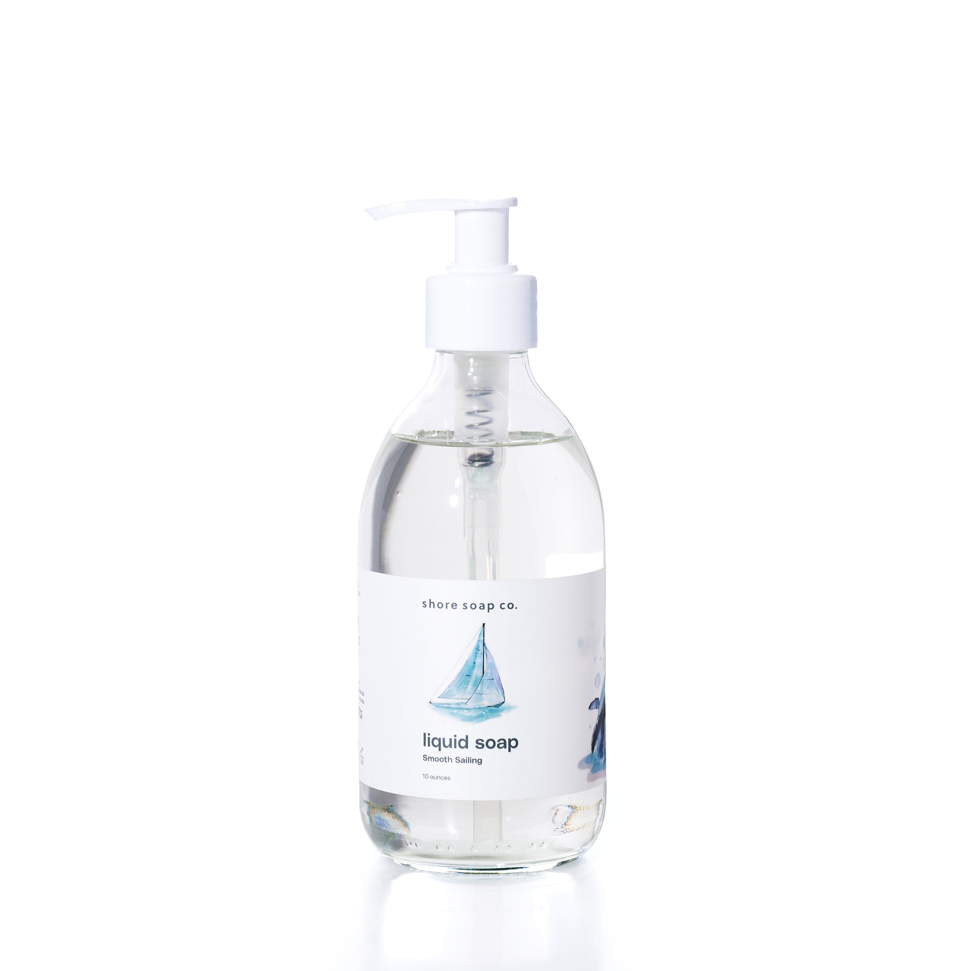 Smooth Sailing Eco-Friendly Liquid Soap by Shore Soap Co comes in a pump bottle featuring an illustration of a sailboat on the label. This gentle, pH-balanced formula is kind to skin, making it perfect for everyday use. by Sea Bags
