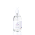 Clear pump bottle of Warm Sand Eco-Friendly Liquid Soap by Shore Soap Co., featuring a white label with a seashell graphic and “ocean scent” text, set against a plain white background. This gentle, pH-balanced formula is crafted to cleanse without harsh ingredients.