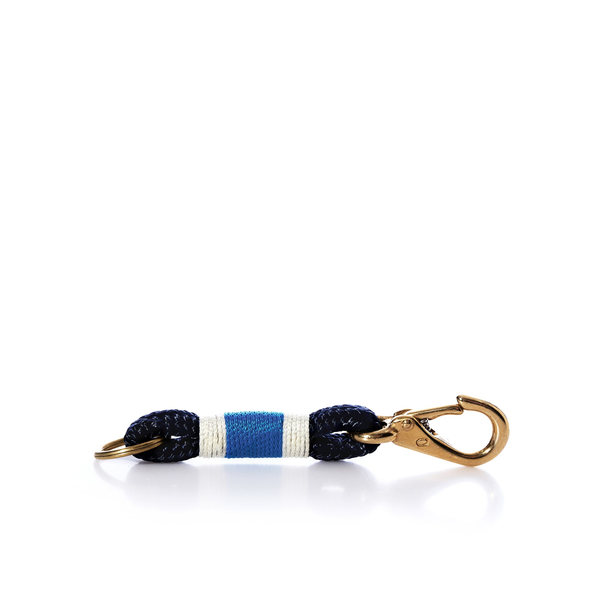 The Fishermans Rope Keychain - Blue, White, Navy by Advanced Industrial Solutions Inc features a metal clasp attached to a short segment of navy blue and white yacht braid rope with a central blue stripe, photographed on a white background—perfect for those seeking Maine-made nautical keychains. by Sea Bags