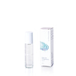 The Atlantic Eco-Friendly Roll-On Fragrance by Shore Soap Co is displayed in a clear glass bottle with a white cap, standing upright beside its matching white packaging box on a white background. This convenient roll-on design makes it an ideal travel perfume, letting you enjoy your favorite scent wherever you go. by Sea Bags