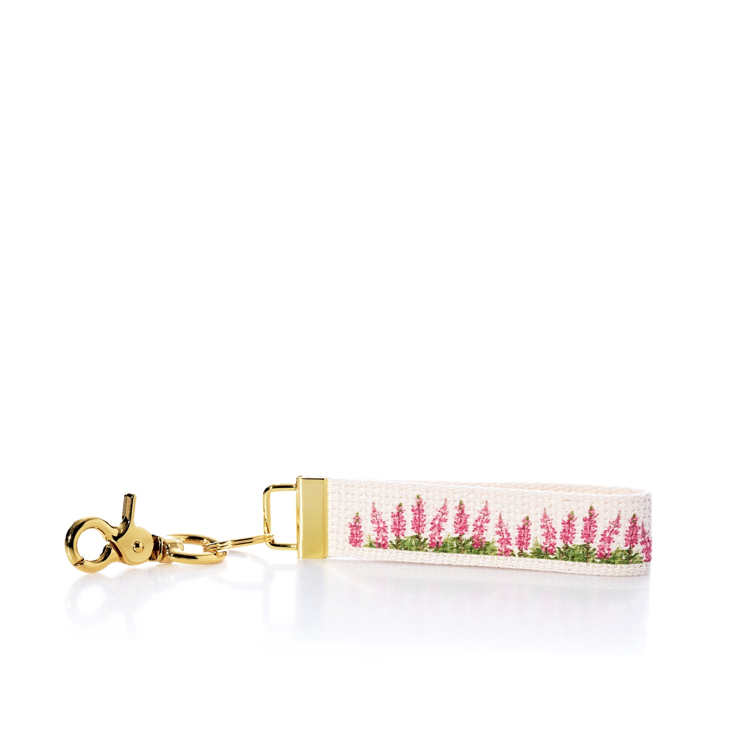 Introducing the Rustic Marlin Keychain - Pink Lupine by Rustic Marlin: a white canvas keychain with a gold clasp, adorned with a lovely pink and green lupine-inspired floral pattern—a charming New England souvenir for any collection. by Sea Bags