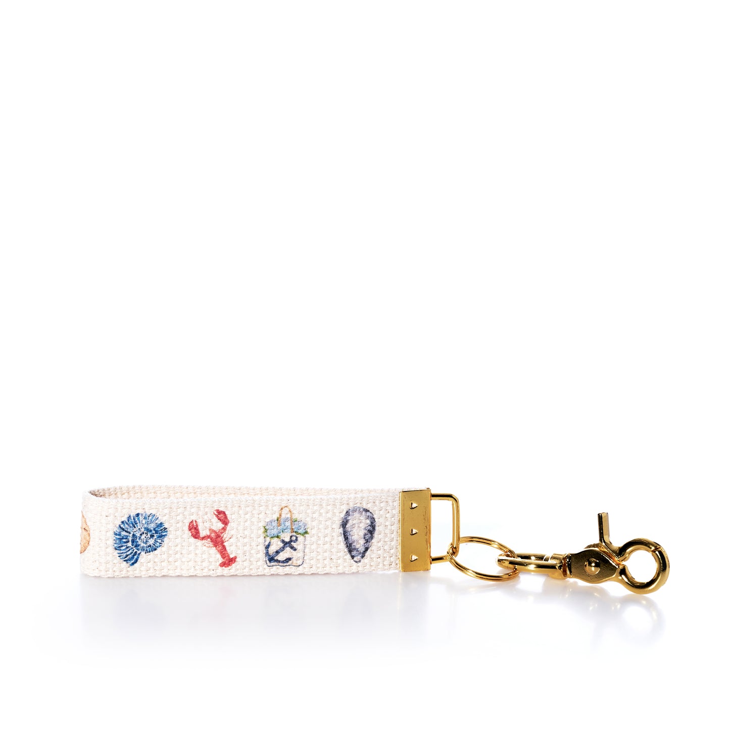 Showcasing embroidered nautical motifs—including a shell, lobster, anchor, and seashell—on a white woven background with gold hardware, the Rustic Marlin Keychain - Summer Icons by Rustic Marlin is a charming accessory that makes the perfect bag charm or souvenir for your coastal adventures. by Sea Bags