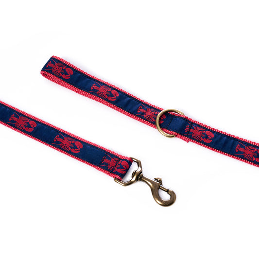 Introducing the Lobsters Dog Leash by Belted Cow—a blue and red leash with a playful lobster pattern, crafted from heavy-duty nylon for adventurous pups. It features a sturdy metal clip and a gold-colored ring, all showcased on a crisp white background.