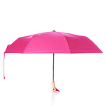 An Original Duck Head Umbrella - Pink by ODH Limited t/a Original Duckhead is fully opened, featuring a black shaft and a light-colored, curved handle shaped like a ducks head, photographed on a white background. This durable umbrella blends style and practicality for everyday use. by Sea Bags