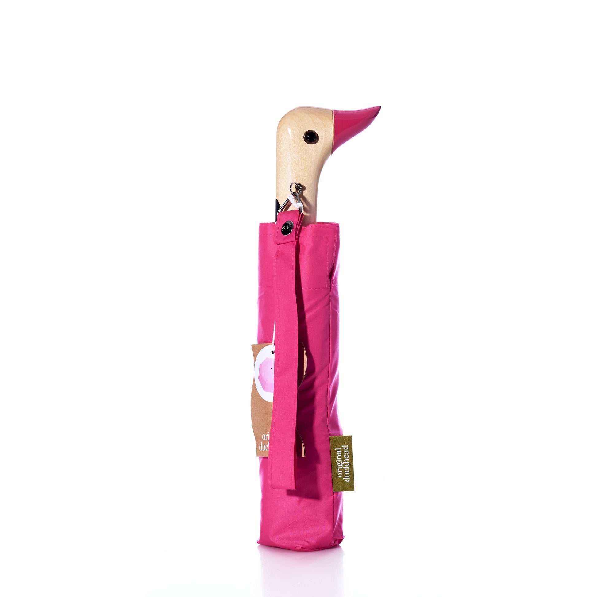 An Original Duck Head Umbrella - Pink by ODH Limited t/a Original Duckhead, featuring a closed design with a charming wooden handle shaped like a birds head and accented with a pink beak, stands upright against a white background. This durable umbrella blends delightful style with everyday practicality. by Sea Bags