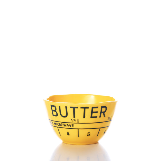 The Butter Dipping Bowl by Merritt International Inc dba Merritt Designs is a yellow plastic bowl labeled BUTTER, featuring measurement markings and a note indicating NOT MICROWAVE. Perfect for your next seafood indulgence as a lobster bake bowl, it is shown set against a white background. by Sea Bags