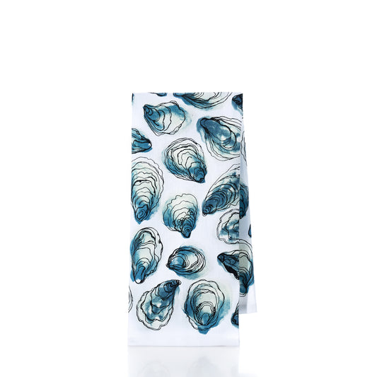 Introducing the Oysters Print Tea Towel by true: crafted from 100 cotton, this white kitchen towel showcases a charming pattern of blue and green oyster shells on a crisp background. Perfect for adding coastal flair to any kitchen.