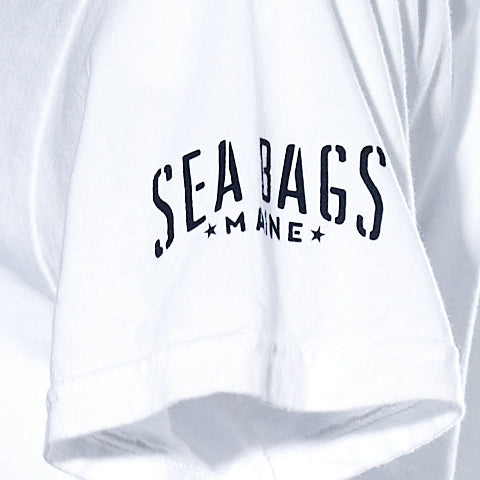 Close-up of a white Wharf Seagull T-Shirt sleeve by 320Ink d/b/a Riptide Print Company, with black text and stars on each side of “MAINE.”.