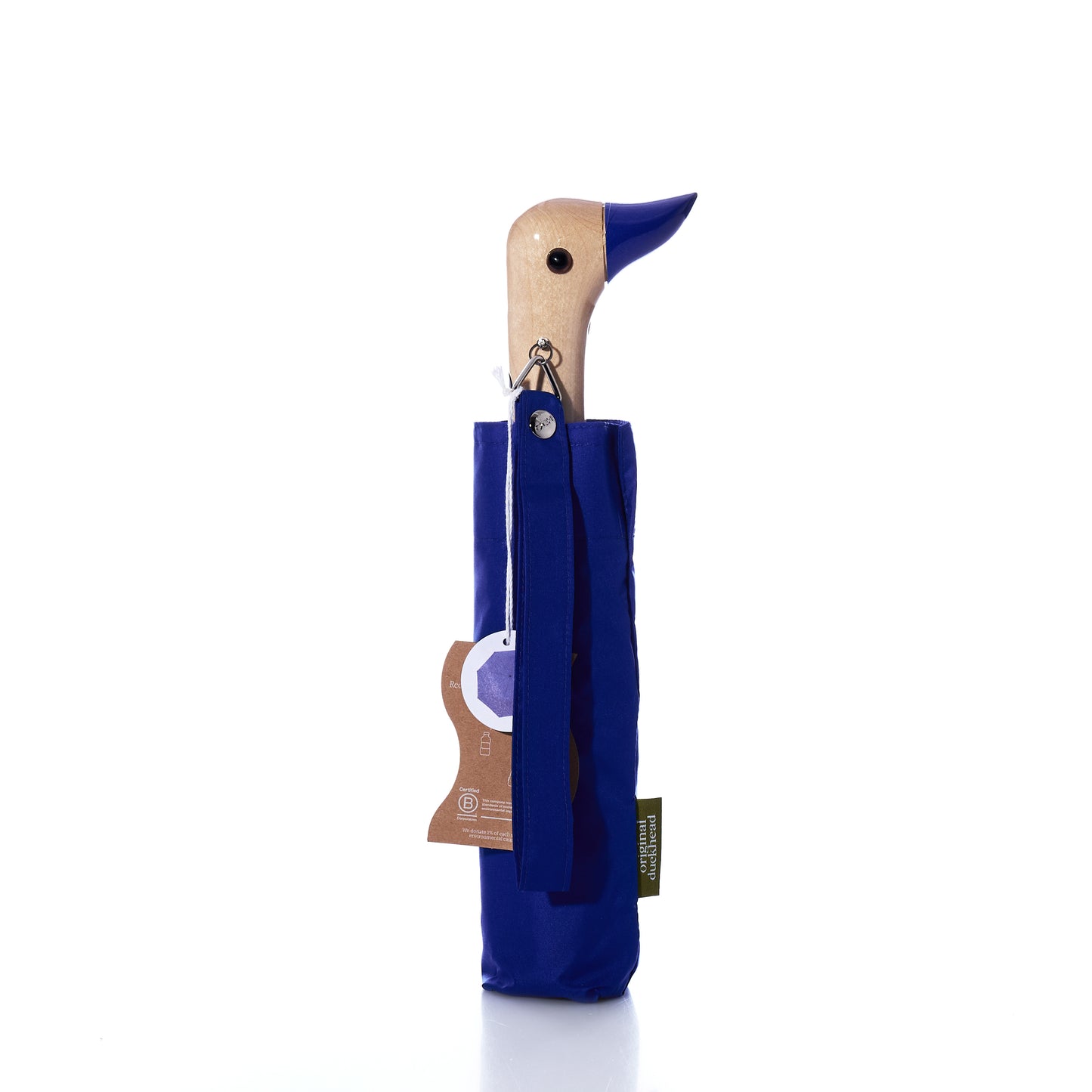 Original Duck Head Umbrella - Cobalt Blue by ODH Limited t/a Original Duckhead, featuring a charming wooden duck-head handle partially sheathed in matching cobalt blue fabric, with product tags attached and set against a white background. This wind-resistant umbrella is thoughtfully crafted for both durability and style.