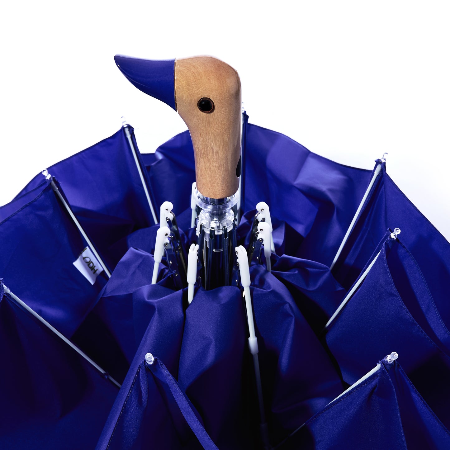 A closed Original Duck Head Umbrella - Cobalt Blue by ODH Limited t/a Original Duckhead, featuring a wooden handle shaped like a duck’s head, is shown from above against a white background. This stylish wind-resistant umbrella combines charm and durability, making it the perfect companion for any rainy day.