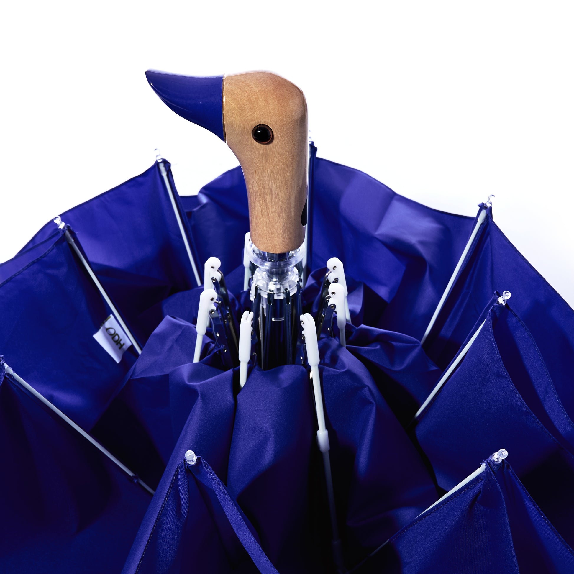 A closed Original Duck Head Umbrella - Cobalt Blue by ODH Limited t/a Original Duckhead, featuring a wooden handle shaped like a duck’s head, is shown from above against a white background. This stylish wind-resistant umbrella combines charm and durability, making it the perfect companion for any rainy day.