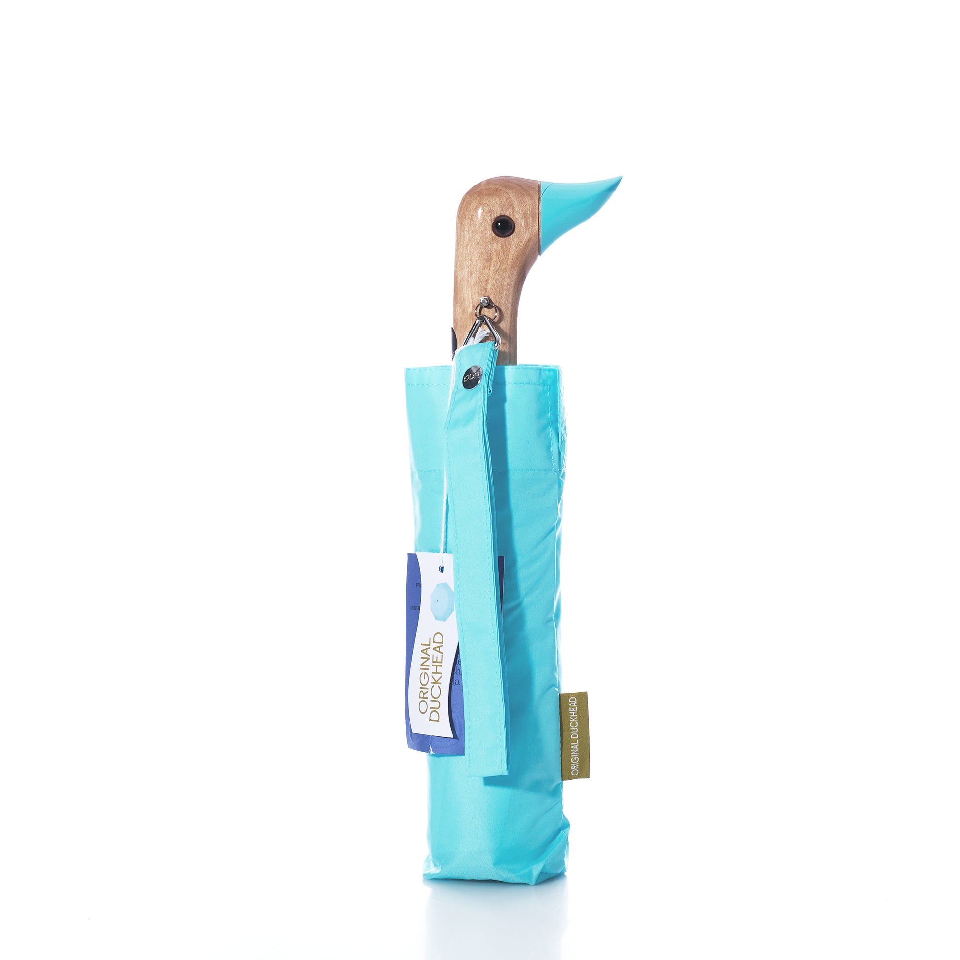 A folded Popsicle Blue Original Duck Head Umbrella by ODH Limited t/a Original Duckhead, featuring a wooden duck head handle and stored in a matching sleeve, is shown against a white background. This wind-resistant umbrella is made from recycled materials, offering style and sustainability for everyday use.