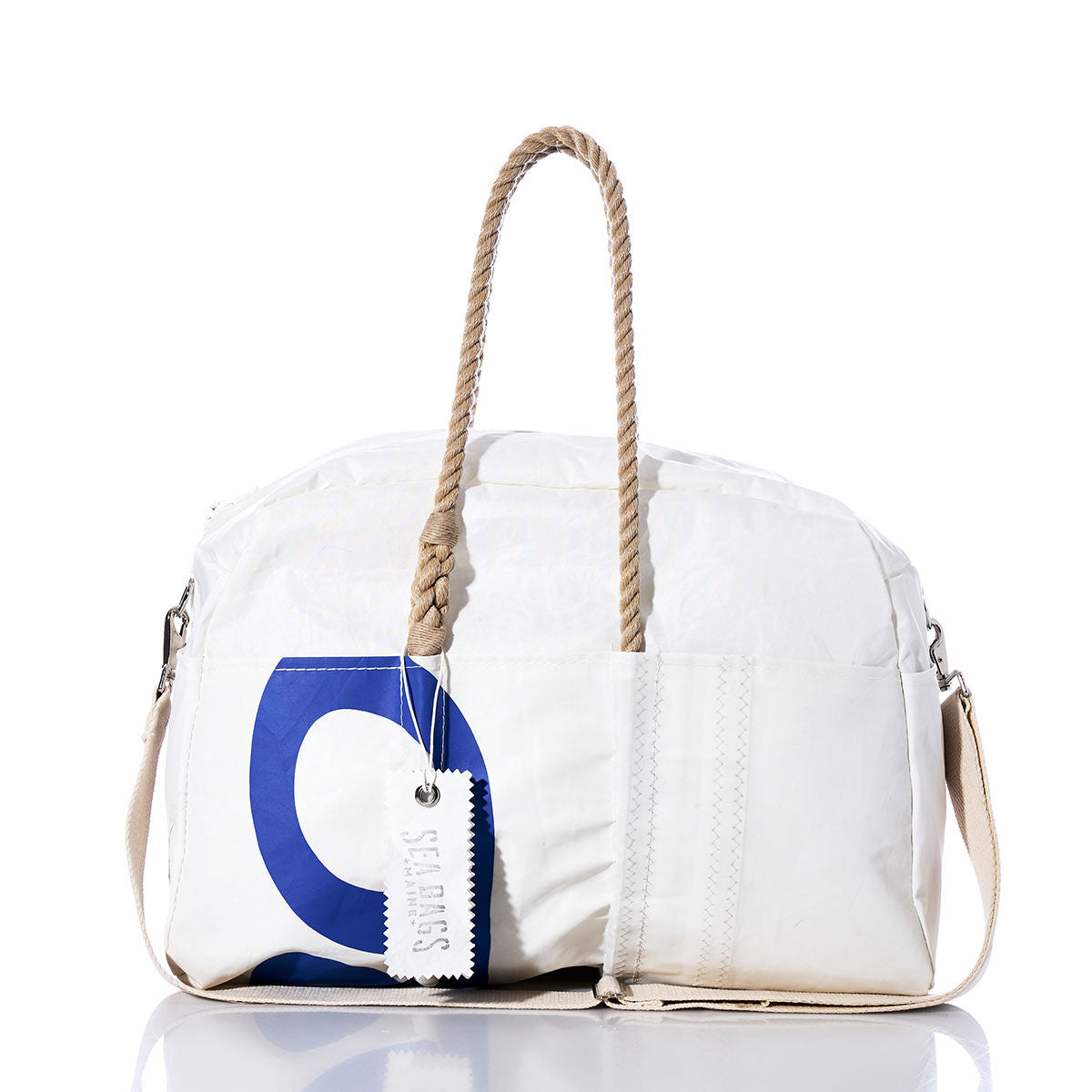 Introducing the Vintage C420 Weekender by Sea Bags—a white duffel bag featuring tan rope and hemp handles, a blue printed design, durable canvas shoulder strap, and a signature white Sea Bags tag. This vintage-style getaway bag is the perfect companion for your next adventure. by Sea Bags