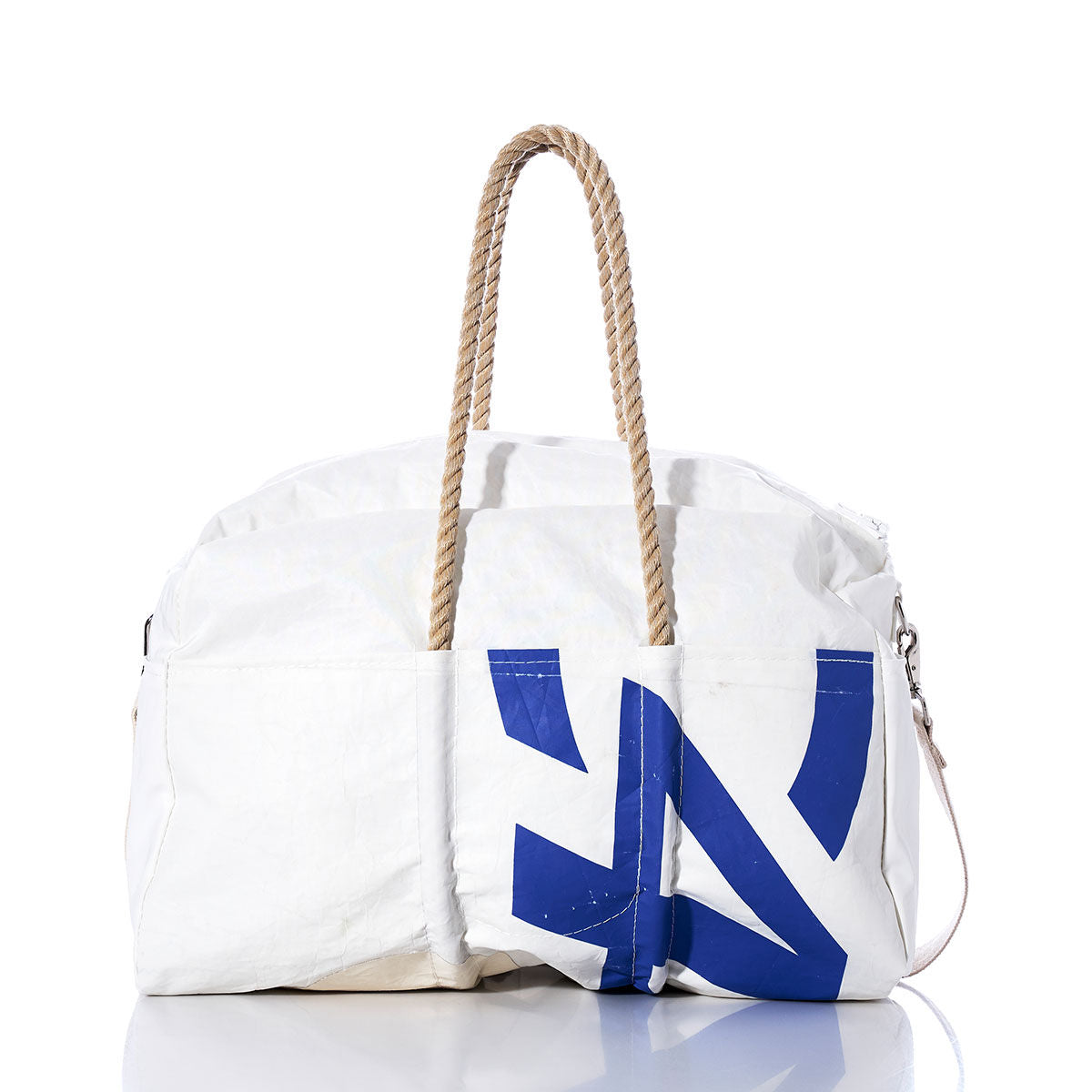 The Sea Bags Vintage C420 Weekender features a blue abstract print on the front, hemp handles, and a detachable shoulder strap, all set against a white background. by Sea Bags
