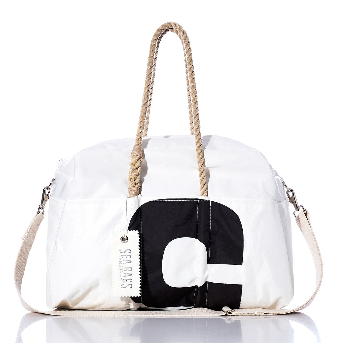 Introducing the Sea Bags Vintage Black 5 Weekender: a white duffel bag featuring sturdy rope handles, a striking vintage black number 5 design, a beige shoulder strap, and an authentic Sea Bags tag—ideal for your next getaway. by Sea Bags
