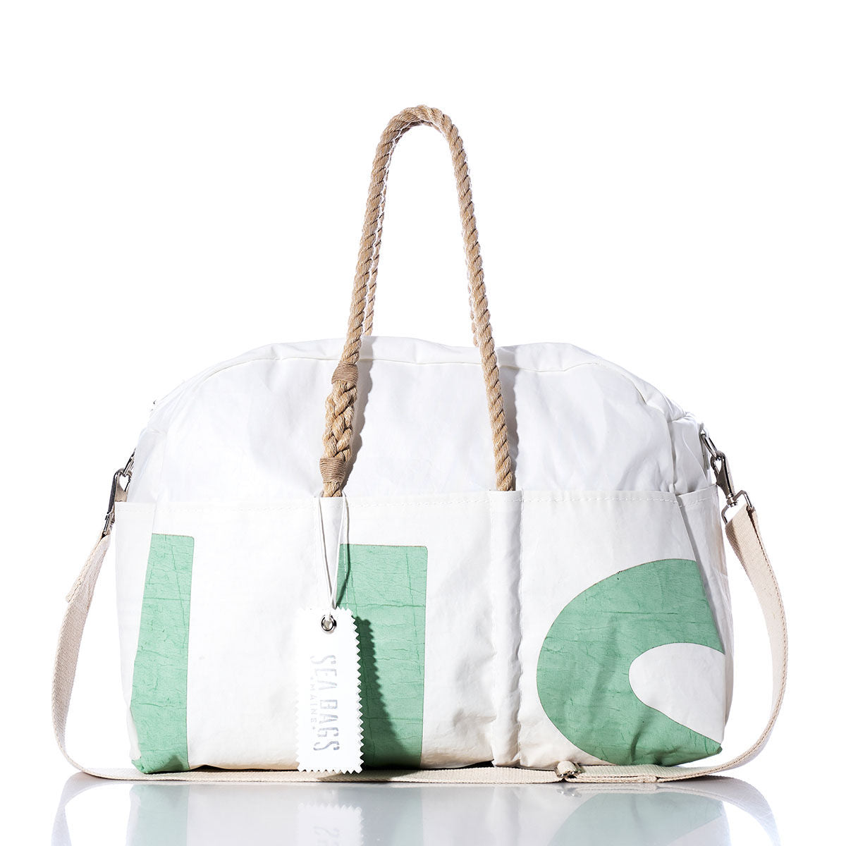 White and green duffel bag featuring rope handles, a removable shoulder strap, and a white tag labeled Sea Bags against a white background—the Vintage US Weekender by Sea Bags is the ultimate getaway bag for your next adventure. by Sea Bags