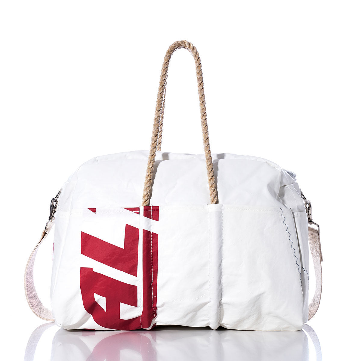 The Sea Bags Vintage Ideal18 Weekender is a vintage-inspired white duffel bag featuring bold red lettering, rope handles, and a detachable shoulder strap—ideal as a stylish weekender bag for your next getaway. Shown against a white background. by Sea Bags