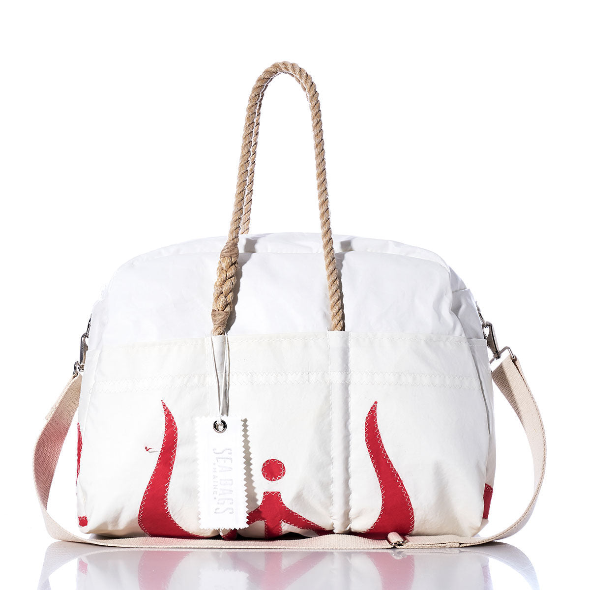 The Vintage Ericson 23 Weekender by Sea Bags features a white exterior with beige hemp handles, a matching beige shoulder strap, striking red accents, and a white tag—displayed on a reflective surface against a white background, this stylish bag is perfect for getaways. by Sea Bags