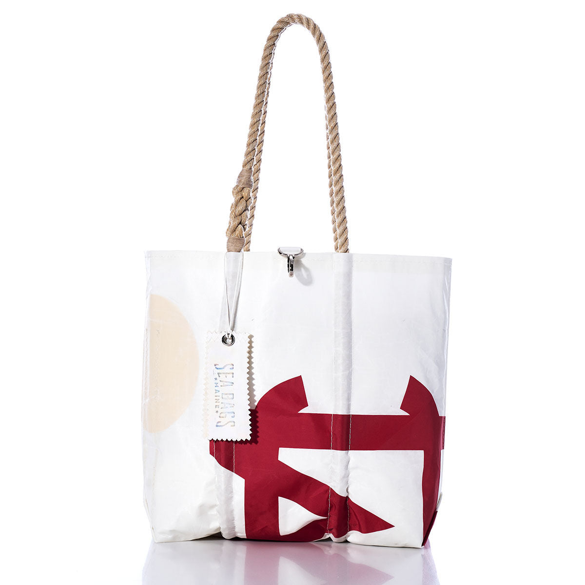The Vintage Melges Medium Tote by Sea Bags is a white sailcloth bag featuring a red abstract design, rope handles, and a hanging tag that reads Sea Bags. Handmade in Maine, this tote is photographed against a white background. by Sea Bags