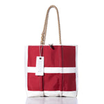 Introducing the Vintage Sonar Medium Tote from Sea Bags: a handmade red and white sailcloth bag with rope handles, featuring a distinctive white cross pattern and a rectangular Sea Bags tag—crafted in Maine. by Sea Bags