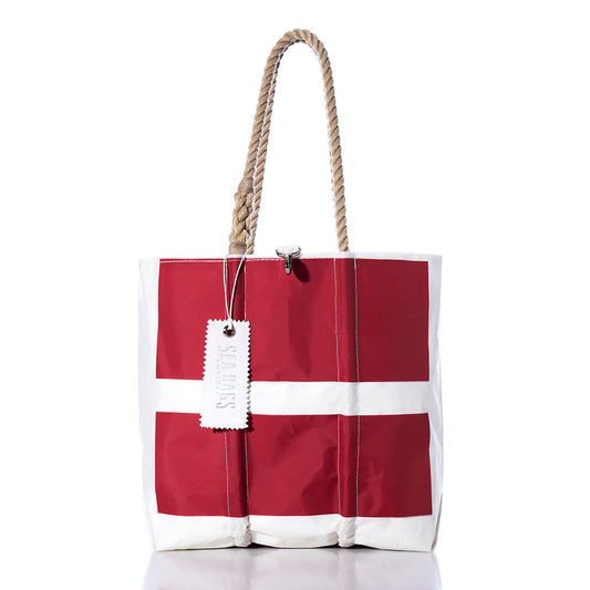 Introducing the Vintage Sonar Medium Tote from Sea Bags: a handmade red and white sailcloth bag with rope handles, featuring a distinctive white cross pattern and a rectangular Sea Bags tag—crafted in Maine. by Sea Bags