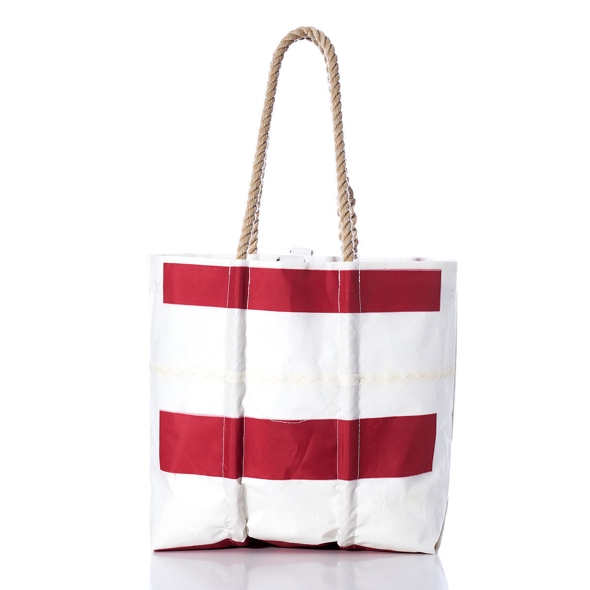 Sea Bags’ Vintage Sonar Medium Tote stands upright against a white background, featuring two horizontal red stripes and rope handles. Handmade in Maine from durable sailcloth, this classic piece effortlessly combines nautical style with practical craftsmanship. by Sea Bags