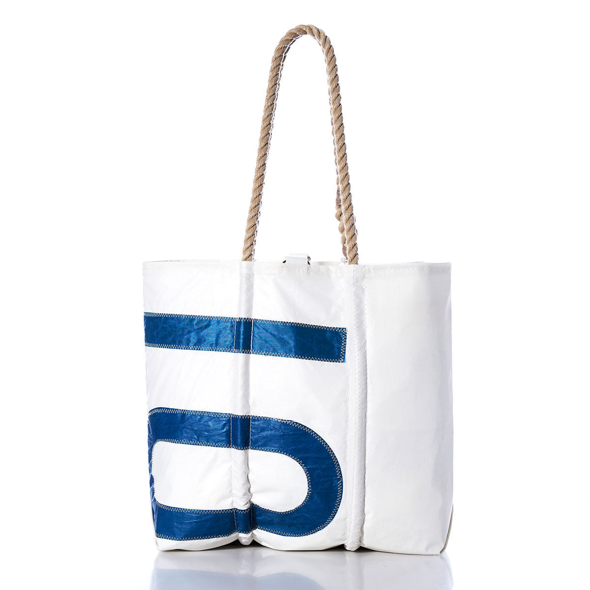 Sea Bags Vintage 1083 Medium Tote features a white sailcloth design with a bold blue number print, hand-spliced rope handles, and visible stitching. Photographed against a white background, this Maine-made tote is crafted from vintage sails. by Sea Bags