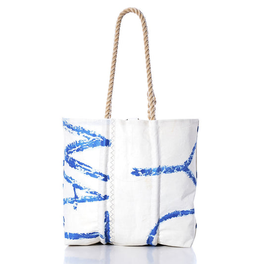 Sea Bags Vintage Blue Letters Medium Tote features a white canvas with bold blue abstract patterns inspired by original sail insignia, finished with sturdy, hand-spliced rope handles and a visible seam—all set against a plain white background. by Sea Bags