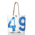 Sea Bags Vintage 49 Medium Tote, crafted in Maine, features hand-spliced rope handles and showcases a large blue number 49 on its white canvas. A white tag is attached near the handle, all set against a plain white background. by Sea Bags