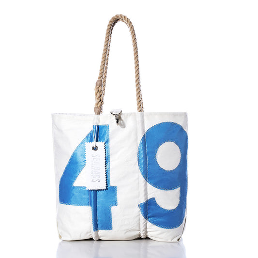 Sea Bags Vintage 49 Medium Tote, crafted in Maine, features hand-spliced rope handles and showcases a large blue number 49 on its white canvas. A white tag is attached near the handle, all set against a plain white background. by Sea Bags