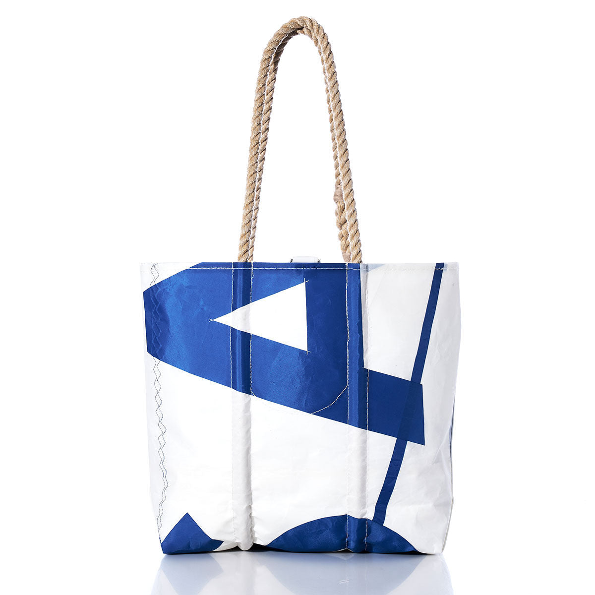 The Sea Bags Vintage USA Medium Tote showcases a white body with a blue geometric pattern and sturdy rope handles, standing upright on a white background. by Sea Bags
