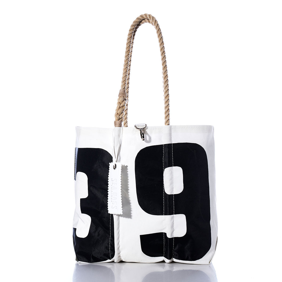 Sea Bags’ Vintage 39 Medium Tote—a white tote featuring bold black numbers 3 and 9, thick hand-spliced rope handles, and a white tag—is inspired by Maine handcrafted bags and displayed against a clean white background. by Sea Bags