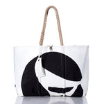 White tote bag featuring a black graphic design, rope handles, and a rectangular tag. The Sea Bags Vintage Sea Sprite Large Tote is expertly handcrafted in Maine from durable sailcloth, blending style with function. Displayed against a plain white background with a subtle reflection underneath. by Sea Bags