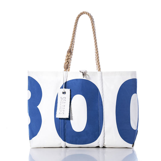 Vintage 300 Large Tote by Sea Bags—a white tote bag adorned with bold blue numbers, featuring hand-spliced rope handles and a rectangular label, inspired by classic Maine-crafted vintage sail bags. by Sea Bags