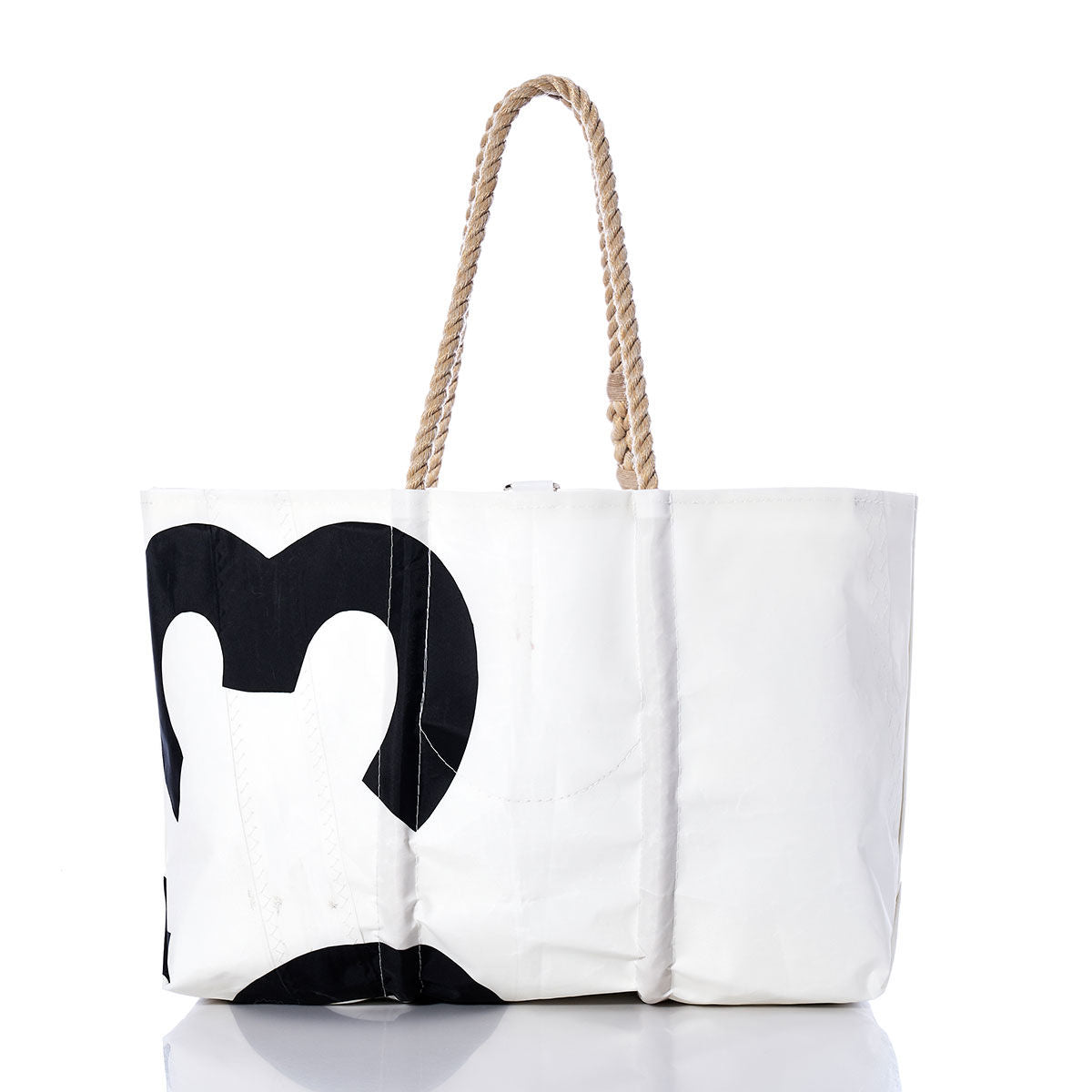 The Sea Bags Vintage 353 Large Tote features a black abstract design on white, accented with hand-spliced rope handles inspired by classic sail tote styles, and is elegantly presented on a reflective surface against a white background. by Sea Bags